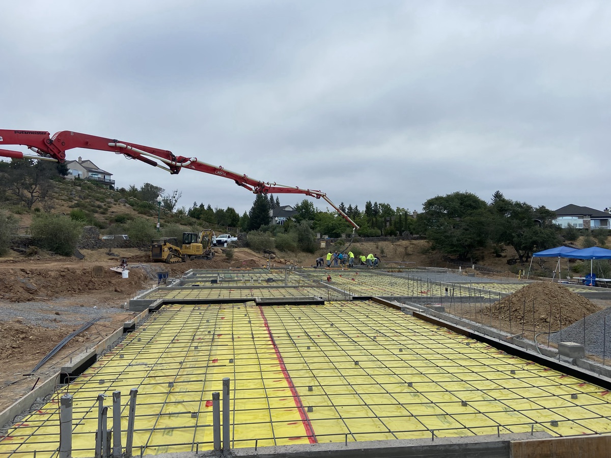 far away view of workers working with freshly poured concrete